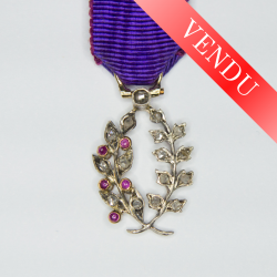 Miniature medal of academic palms with diamonds, rubies and ribbon.