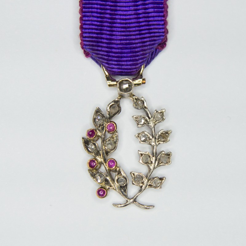 Miniature medal of academic palms with diamonds, rubies and ribbon.