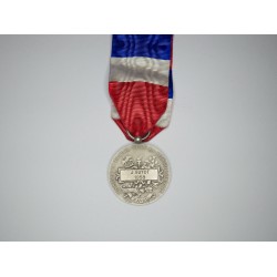 Silver labor medals with ribbon.