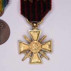 Miniature medal chainette, including gold war cross.