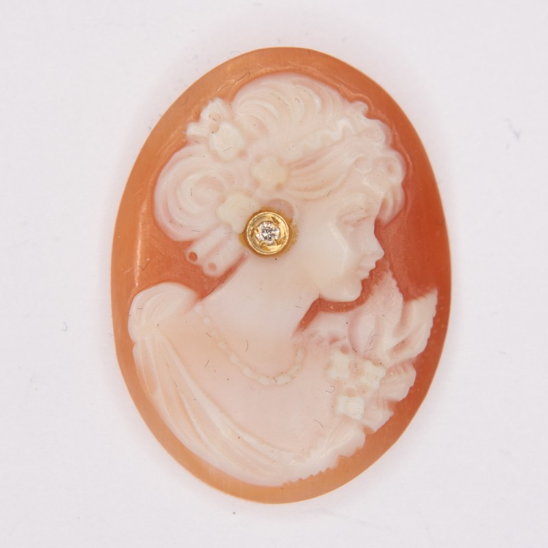 Beautiful old oval cameo, representing the profile of a woman, with gold ear nail setting a diamond.