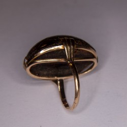 Gold-rimmed ring adorned with an amber cabochon (accidents).